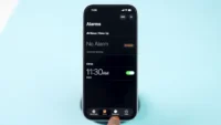 Open Settings on iPhone to adjust alarm volume.
